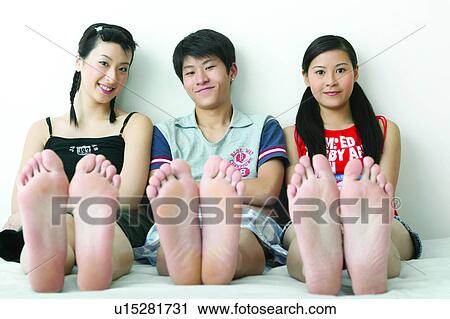 Stock Image - Cheerful, Sitting, 16-17 Years, Togetherness, Tank Top, Leaning, Sole Of Foot. Fotosearch