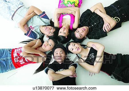 Close-Up, Lying On Back, Group Of People, Waist-Up, Togetherness, Jeans View Large Photo Image Stock Photo - Close-Up, Lying On Back, Group Of People, Waist-Up, Togetherness, Jeans. Fotosearch