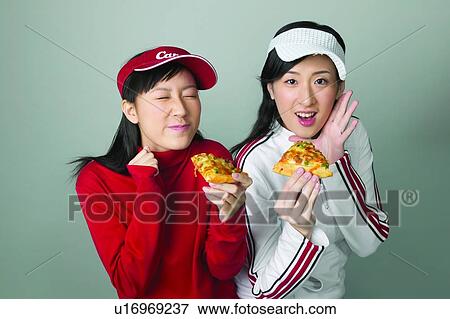 Stock Photo - East, Holding, Adolescence, Casual Clothing, Eyes Closed, Looking At Camera. Fotosearch