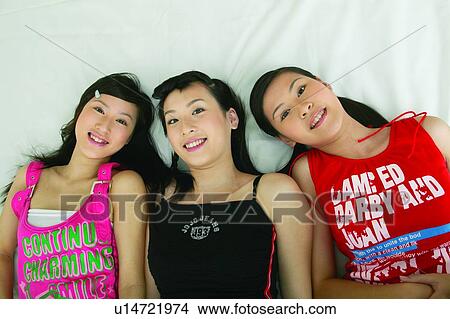Picture - Indoor, Adolescence, Togetherness, Looking At Camera, Side By Side. Fotosearch