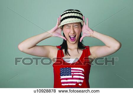 Stock Photo - Indoor, Eyes Closed, Sleeveless Top, Standing. Fotosearch