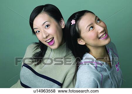 Indoor, Leisure Activity, Teenagers, Casual Clothing, Asian Ethnicity Teenager, Colored Background, Looking At Camera View Large Photo Image Stock Photo - Indoor, Leisure Activity, Teenagers, Casual Clothing, Asian Ethnicity Teenager, Colored Background, Looking At Camera. Fotosearch