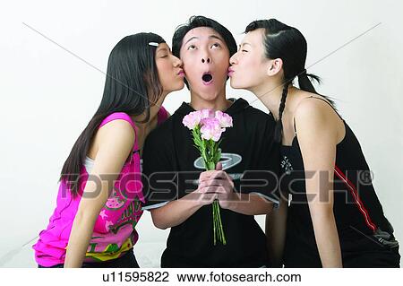 Stock Image - Love, Colour Horizontal, Eyes Closed, Casual Clothing, Making A Face, Teenage Boys, Asian Ethnicity. Fotosearch