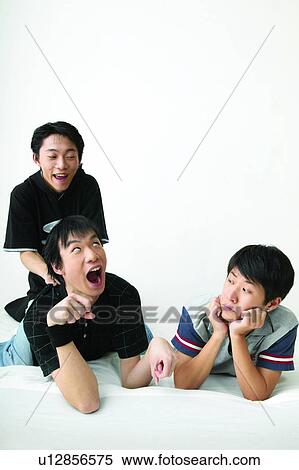 Lying Down, Adolescence, Enjoyment, Looking Up, Togetherness, 16-17 Years, Fun View Large Photo Image Stock Photography - Lying Down, Adolescence, Enjoyment, Looking Up, Togetherness, 16-17 Years, Fun. Fotosearch