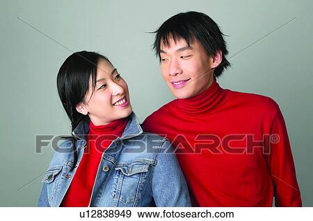 Stock Photo - Standing, Denim Jacket, Adolescence, Happiness, Love, Teenagers Only. Fotosearch
