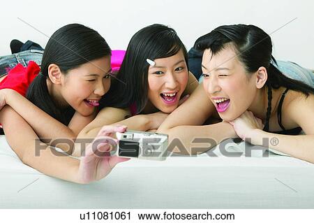 Stock Image - Teenagers Only, Adolescence, Memories, Cheerful, Casual Clothing, Bed. Fotosearch