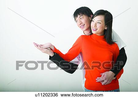 Stock Photograph - Teenagers, Romance, Togetherness Happiness, Embracing, Close-Up, Teenage Boys, Asian. Fotosearch