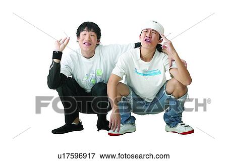 Stock Photo - Cap, Adolescence, Black Hair, Asian Ethnicity, Arm Around, Casual Clothing, 16-17 Years. Fotosearch