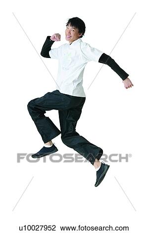 Stock Image - Jumping, 16-17 Years, Clipping Path, T-Shirt, Excitement, Toothy Smile. Fotosearch