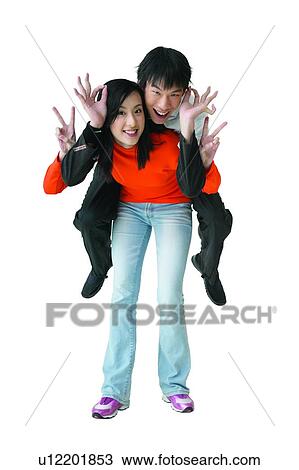 Stock Image - T-Shirt, Happiness, Friendship, Teenage Boys, Jeans, Hand Sign, Teenagers Only. Fotosearch