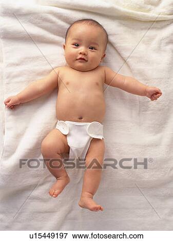Stock Photo - Baby boy lying on back, portrait, high angle view. Fotosearch