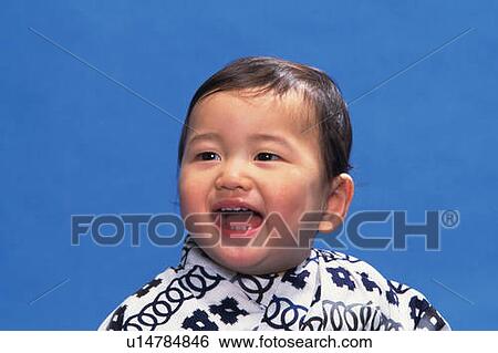 Stock Photograph - Baby boy wearing yukata, smiling, front view, portrait. Fotosearch