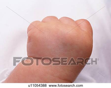 Stock Photo - Close up baby's left hand, high angle view . Fotosearch