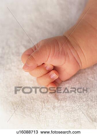 Stock Image - Close up baby's right hand, high angle view . Fotosearch