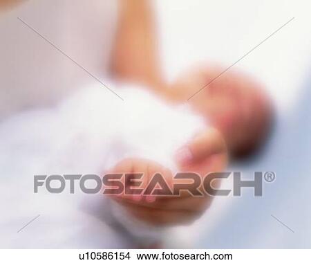 Picture - Close up of baby boy with mother, portrait, side view, defocused. Fotosearch
