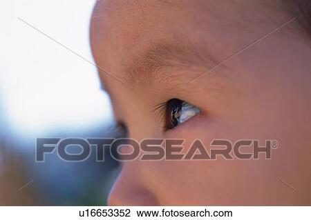 Stock Image - Close up of baby's face, side view, Full Frame. Fotosearch
