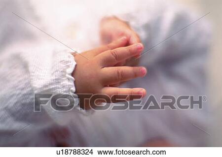 Picture - Close up of baby's hand, lying on back, high angle view, Differential Focus, Full Frame. Fotosearch