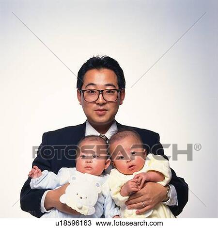 Father holding twins baby boys View Large Photo Image Stock Image - Father holding twins baby boys. Fotosearch