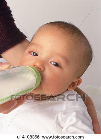 Mother feeding baby boy, portrait, side view View Large Photo Image Stock Photograph - Mother feeding baby boy, portrait, side view. Fotosearch