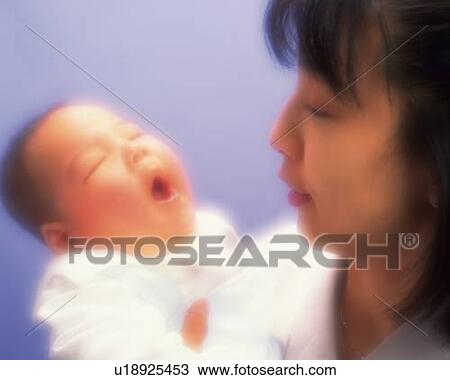 Mother holding baby boy, baby yawning, portrait, high angle view, defocused View Large Photo Image Stock Image - Mother holding baby boy, baby yawning, portrait, high angle view, defocused. Fotosearch