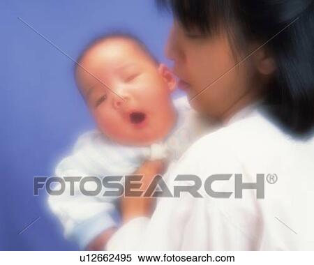 Mother holding baby boy, baby yawning, portrait, front view, defocused View Large Photo Image Stock Photography - Mother holding baby boy, baby yawning, portrait, front view, defocused. Fotosearch