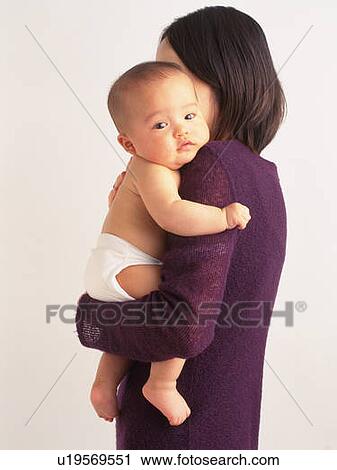 Mother holding baby boy, portrait, side view View Large Photo Image Stock Image - Mother holding baby boy, portrait, side view. Fotosearch