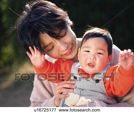 Mother with baby girl, portrait, front view View Large Photo Image Stock Photo - Mother with baby girl, portrait, front view. Fotosearch