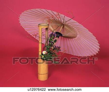Stock Image - A bangasa and flower arrangement in the bamboo vase, High Angle View, Close Up. Fotosearch