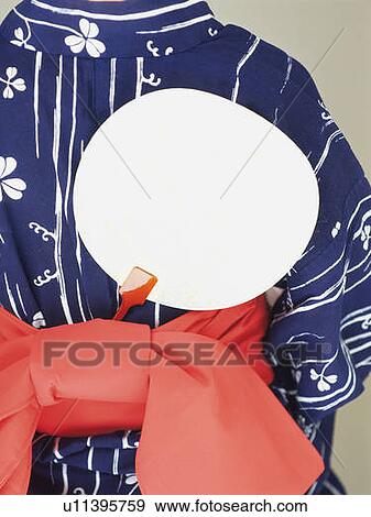 Stock Photo - A fan put in the belt of the back of a woman's kimono, Close Up. Fotosearch