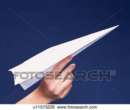 Stock Photo - A hand holding a paper airplane, Close Up, Side View. Fotosearch