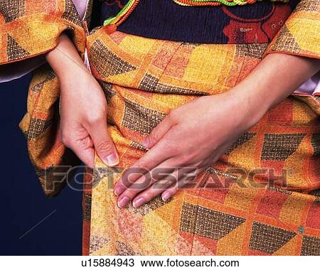 Stock Image - A woman adjusting her kimono, Front View, Close Up. Fotosearch