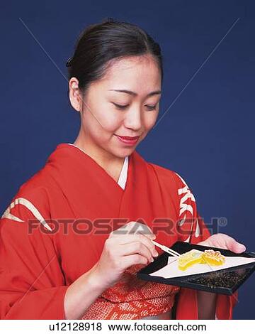 A woman in kimono eating Japanese sweets, Side View View Large Photo Image Stock Photo - A woman in kimono eating Japanese sweets, Side View. Fotosearch