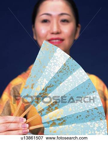 A woman in kimono holding a Japanese fan, Close Up, Differential Focus View Large Photo Image Stock Photo - A woman in kimono holding a Japanese fan, Close Up, Differential Focus. Fotosearch