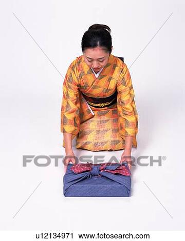 A Woman In Kimono Sitting And Bowing High Angle View Stock Image U Fotosearch