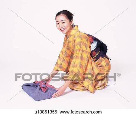 A woman in kimono sitting and holding a gift, High Angle View, Side View View Large Photo Image Stock Photography - A woman in kimono sitting and holding a gift, High Angle View, Side View. Fotosearch