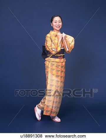 A woman in kimono smiling and posing, Side View View Large Photo Image Stock Photo - A woman in kimono smiling and posing, Side View. Fotosearch