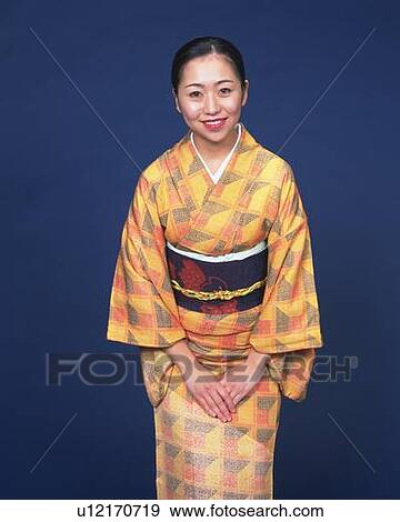 Stock Photo - A woman in kimono smiling, Front View. Fotosearch