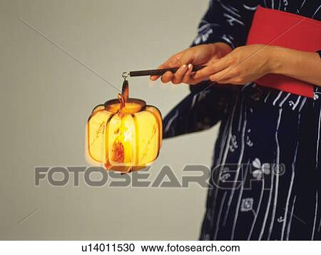 A woman in yukata holding a Japanese lantern, Close Up View Large Photo Image Stock Image - A woman in yukata holding a Japanese lantern, Close Up. Fotosearch