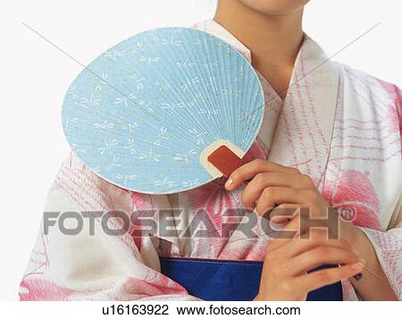 A woman in yukata holding a Japanese fan, Close Up, Front View View Large Photo Image Stock Image - A woman in yukata holding a Japanese fan, Close Up, Front View. Fotosearch