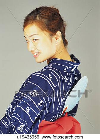 Stock Photograph - A woman in yukata looking back, Rear View. Fotosearch