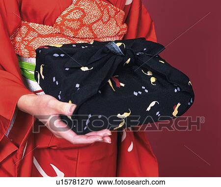 Hands of a woman in kimono holding a gift, Close Up View Large Photo Image Stock Image - Hands of a woman in kimono holding a gift, Close Up. Fotosearch