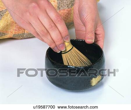 Stock Image - Hands of a woman in kimono making Japanese tea, High Angle View, Close Up. Fotosearch