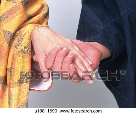 Stock Image - Holding hands, Close Up. Fotosearch