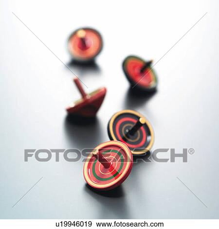 Five spinning tops, high angle view, white background, differential focus View Large Photo Image Stock Photo - Five spinning tops, high angle view, white background, differential focus. Fotosearch