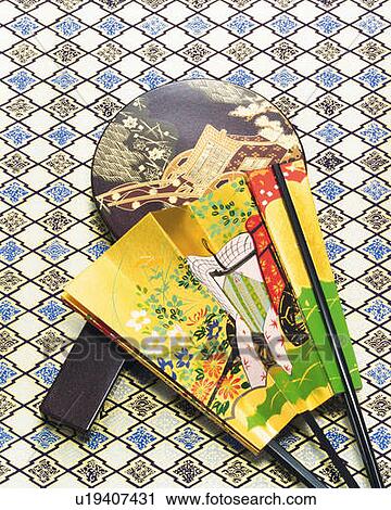 Stock Image - Japanese folding fan and hand mirror, high angle view. Fotosearch