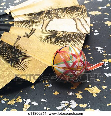 Stock Image - Japanese folding fan and Temari ball, high angle view. Fotosearch