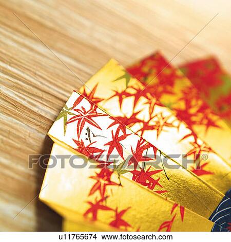 Japanese folding fan painted maple leaves in autumnal color, high angle view, close up, differential focus View Large Photo Image Picture - Japanese folding fan painted maple leaves in autumnal color, high angle view, close up, differential focus. Fotosearch