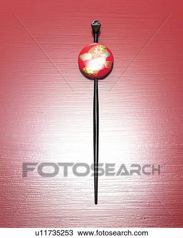 Stock Image - Japanese hairpin, front view, red background. Fotosearch