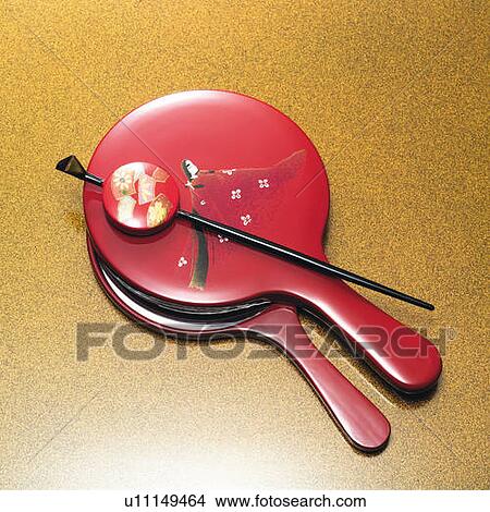 Picture - Japanese hairpin on hand mirrors, high angle view, gold background. Fotosearch