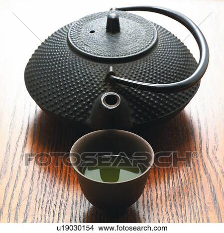 Picture - Japanese tea cup and tea pot on grained surface, high angle view, Japan. Fotosearch